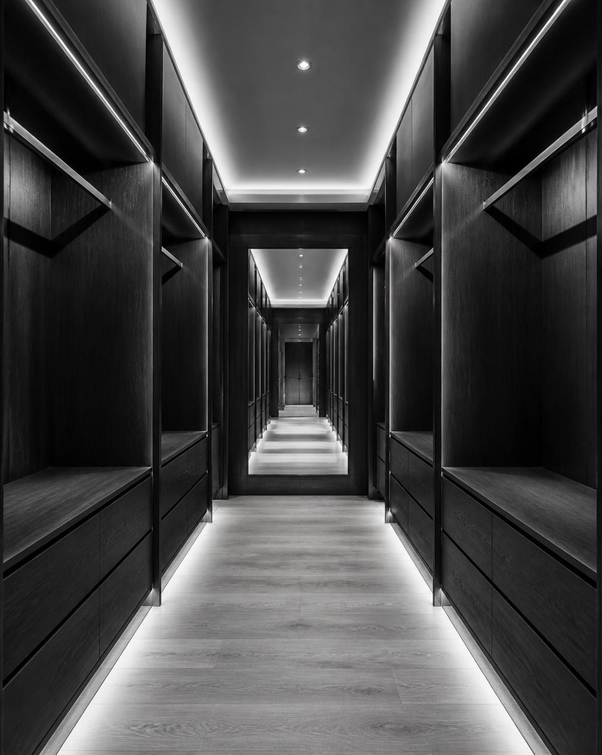 Monochrome interior study: narrow boutique corridor with cove lighting