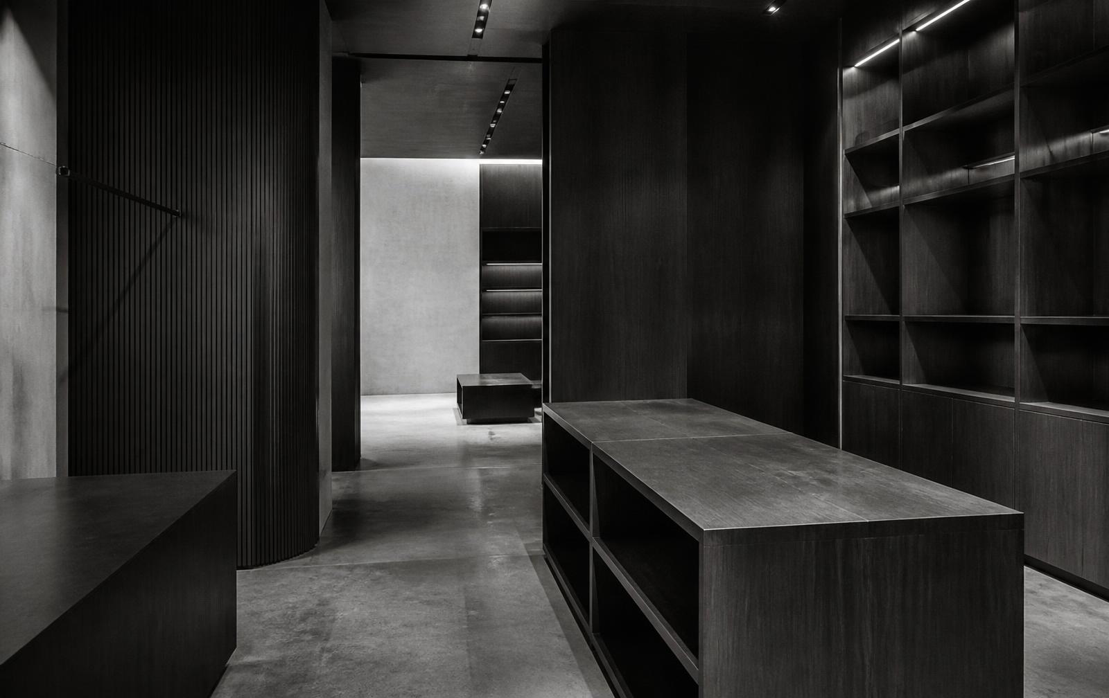 Monochrome interior study: dark millwork and concrete floor